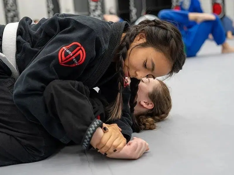 Women&rsquo;s Jiu Jitsu class drilling wrist control and ground defense techniques
