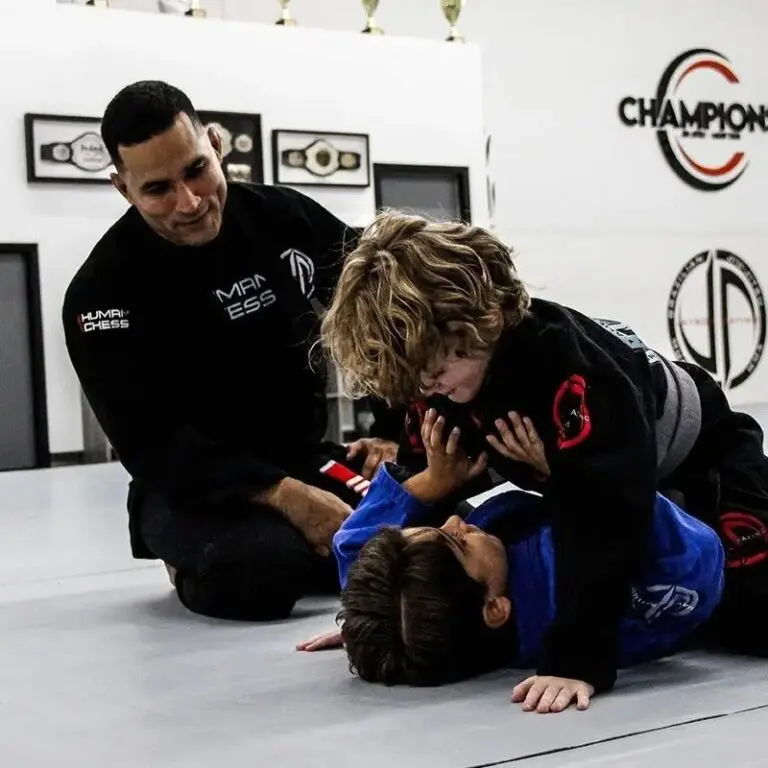 BJJ instructor coaching children during grappling drill at Orlando martial arts academy