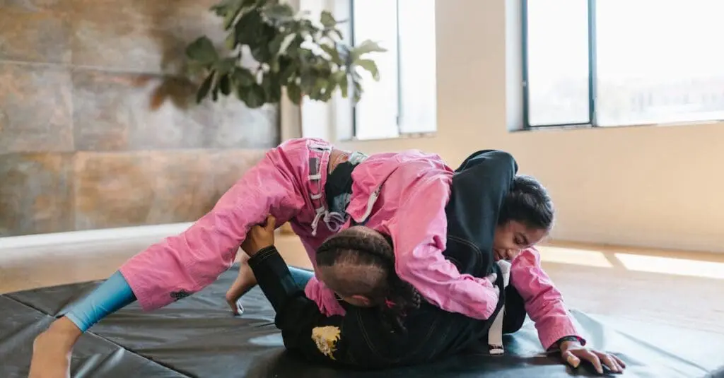 BJJ students practicing top control on mats during teen Jiu Jitsu training