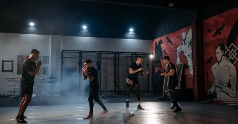 Students practicing self defense sparring drills in a martial arts training gym