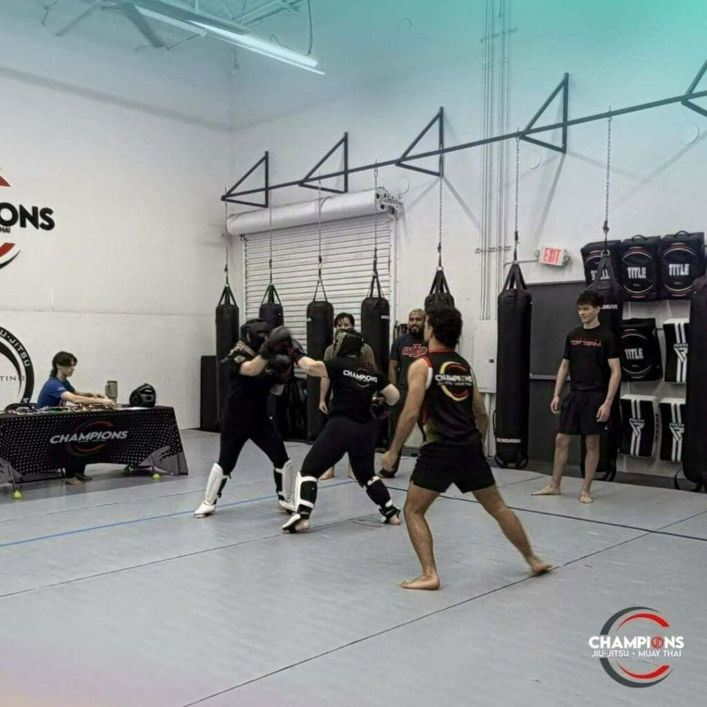 Martial arts students practicing controlled sparring with protective gear under instructor supervision to strengthen martial arts training fundamentals.