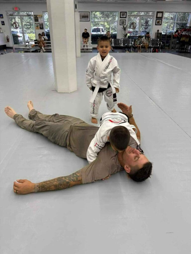 Two martial arts students facing each other in protective equipment during a controlled sparring session focused on martial arts training fundamentals.