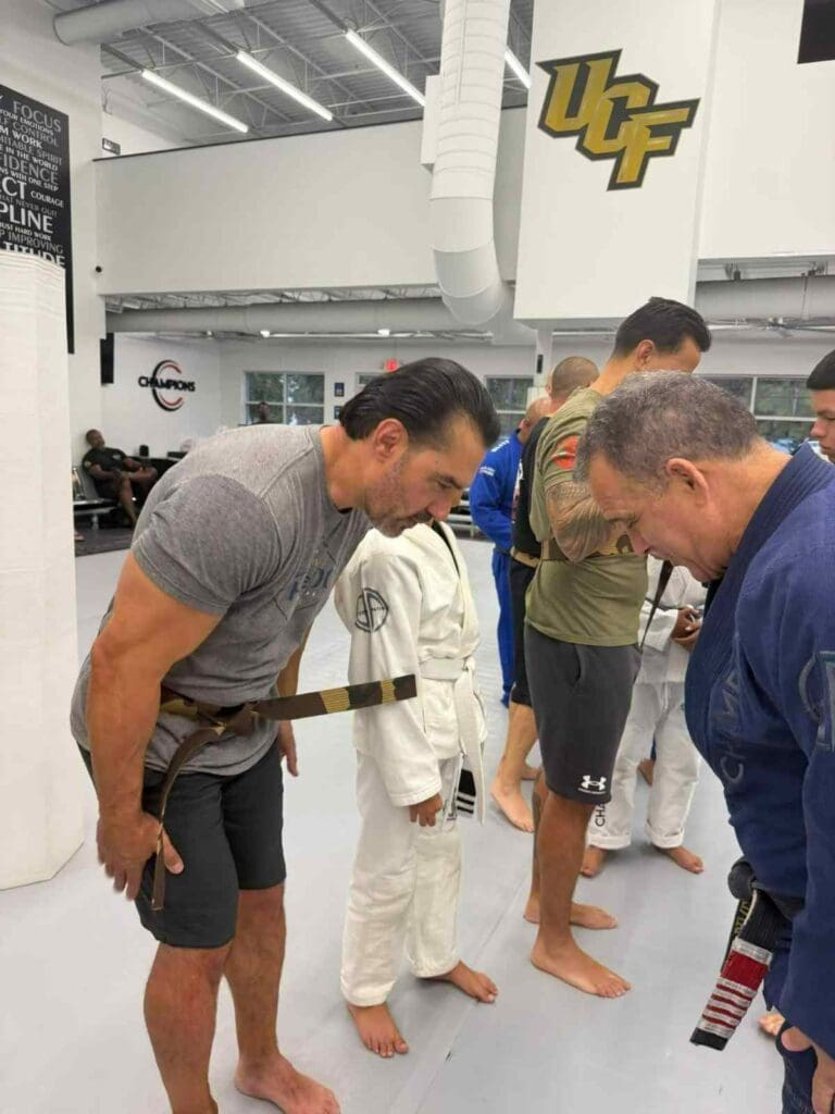 Children and adults participating together in a Brazilian Jiu-Jitsu class while developing coordination, discipline, and martial arts training fundamentals.