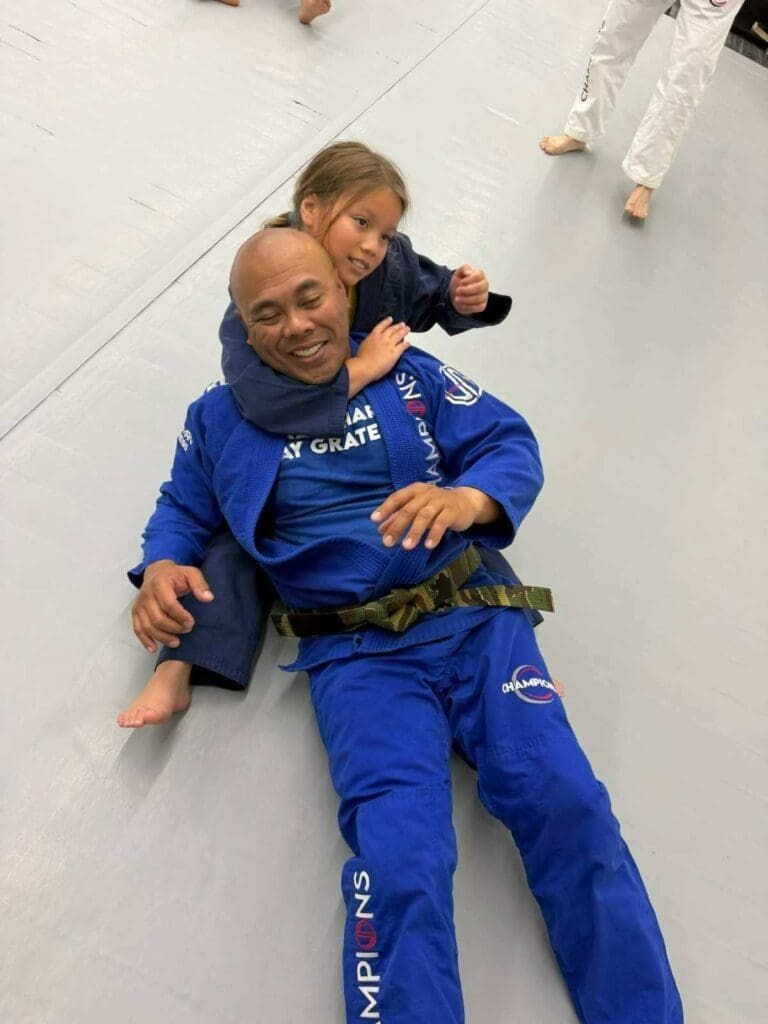 Adult and young Brazilian Jiu-Jitsu students showing respect before training as part of proper martial arts training fundamentals.